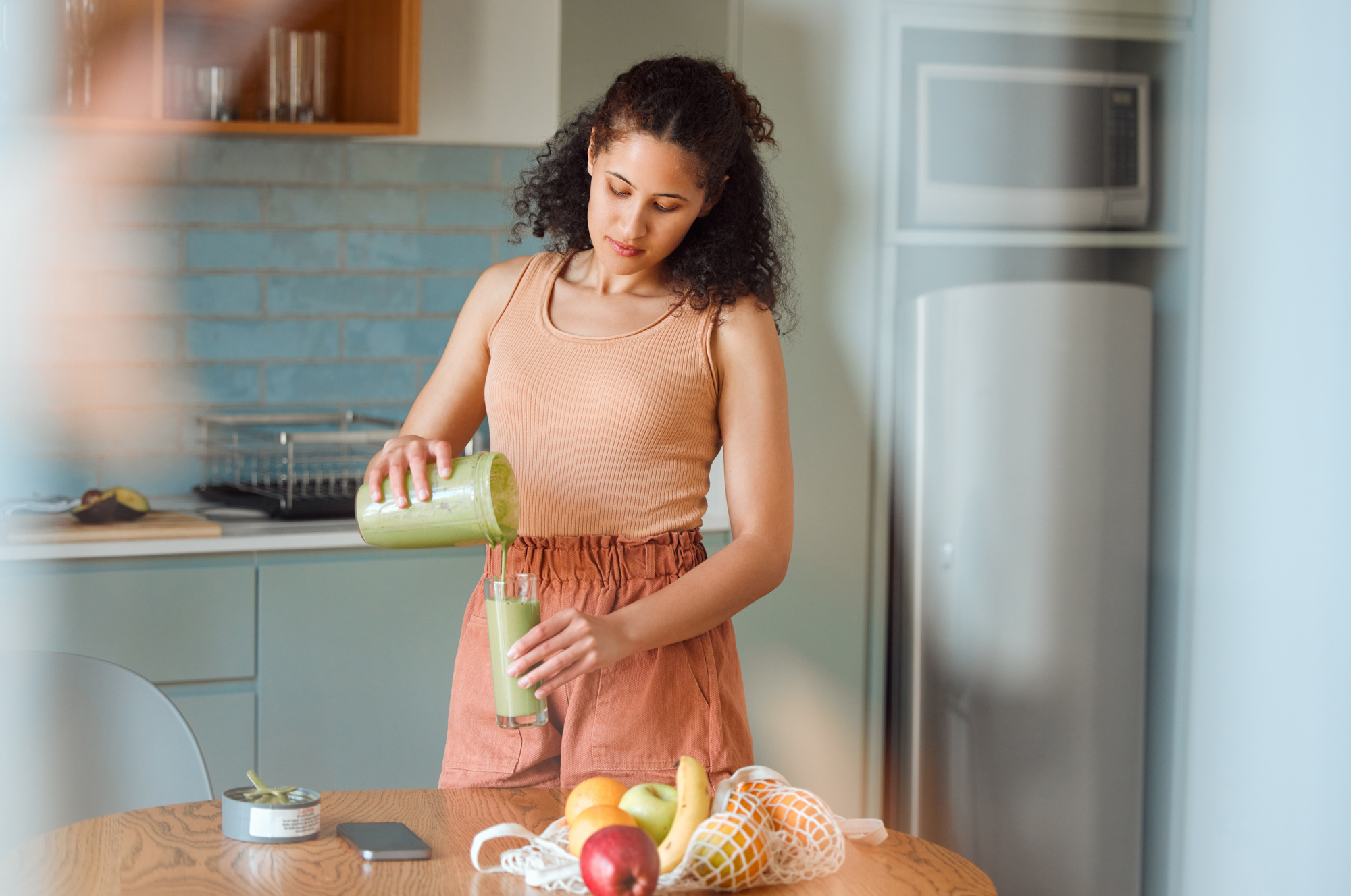 Young woman making a nutritious meal to support medical weight loss