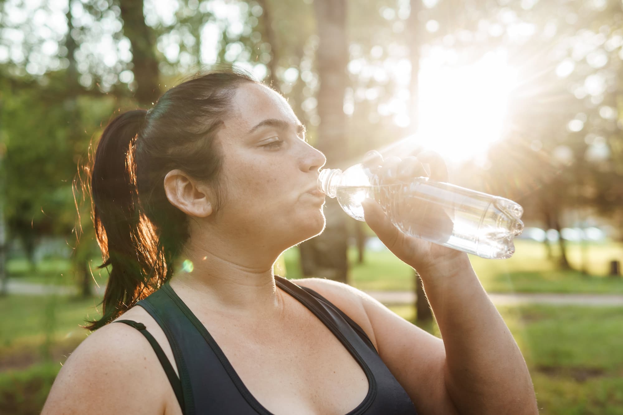 A woman drinks water and exercise for weight loss.