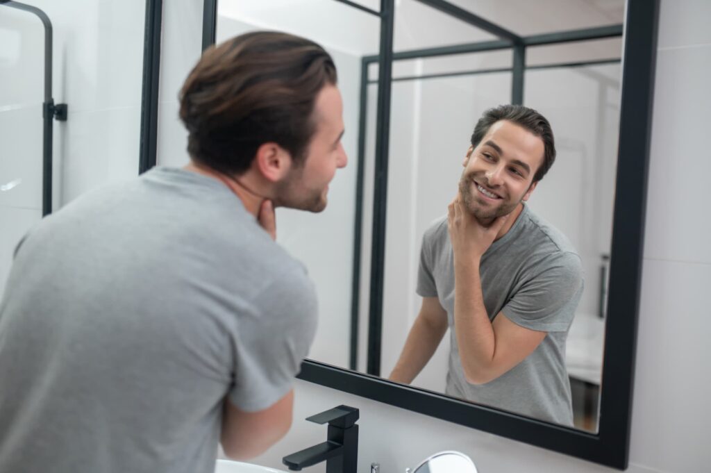 Man noticing hair growth from Nutrafol in Denver in the mirror