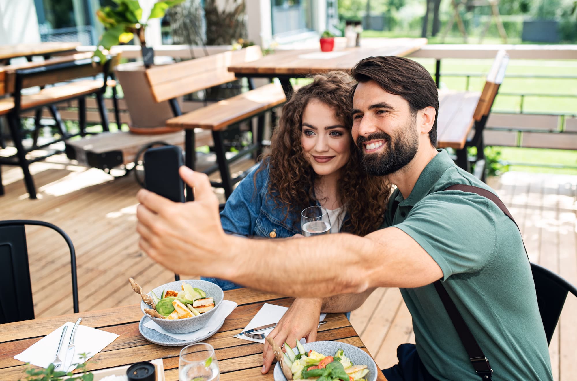 Happy couple taking a photo at dinner in Denver