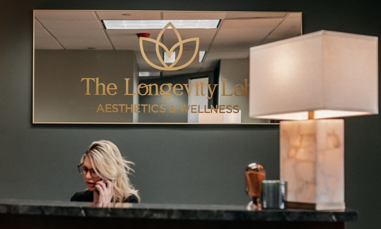 A woman working at front desk of The Longevity Lab in Denver