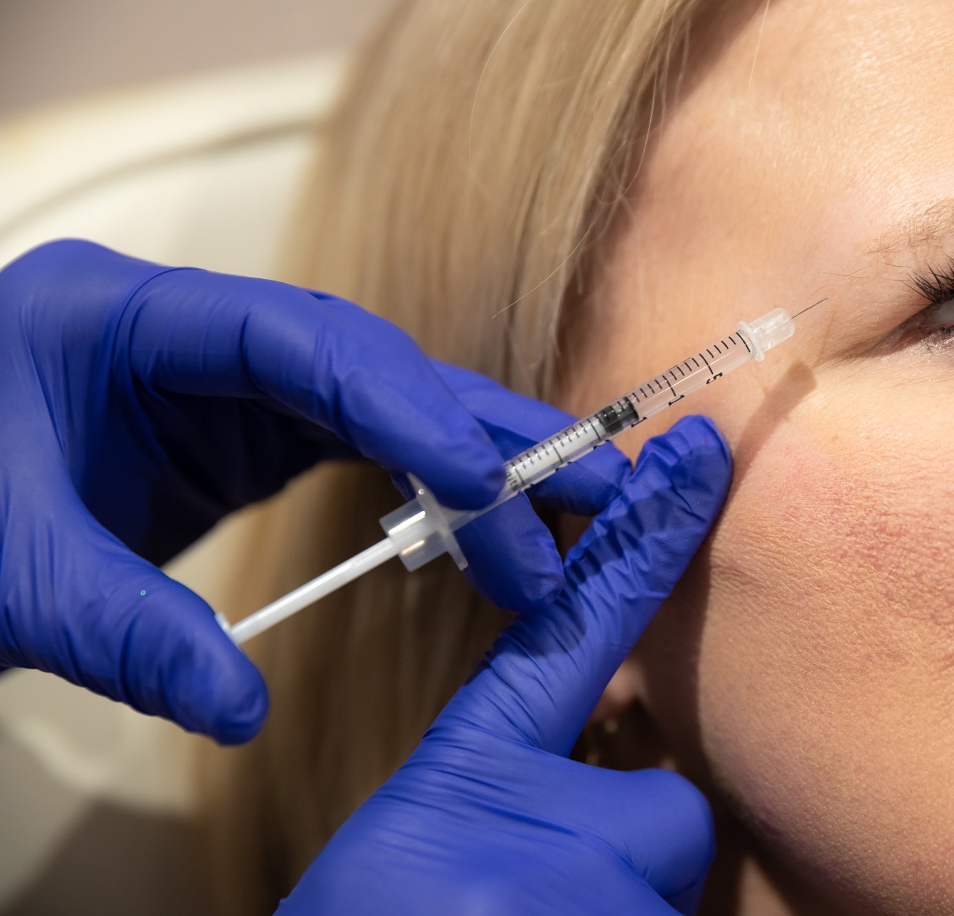 Close up of a woman receiving an injection to treat wrinkles