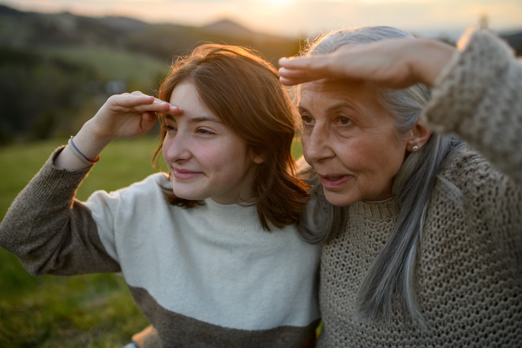 A woman and her granddaughter looking outdoors