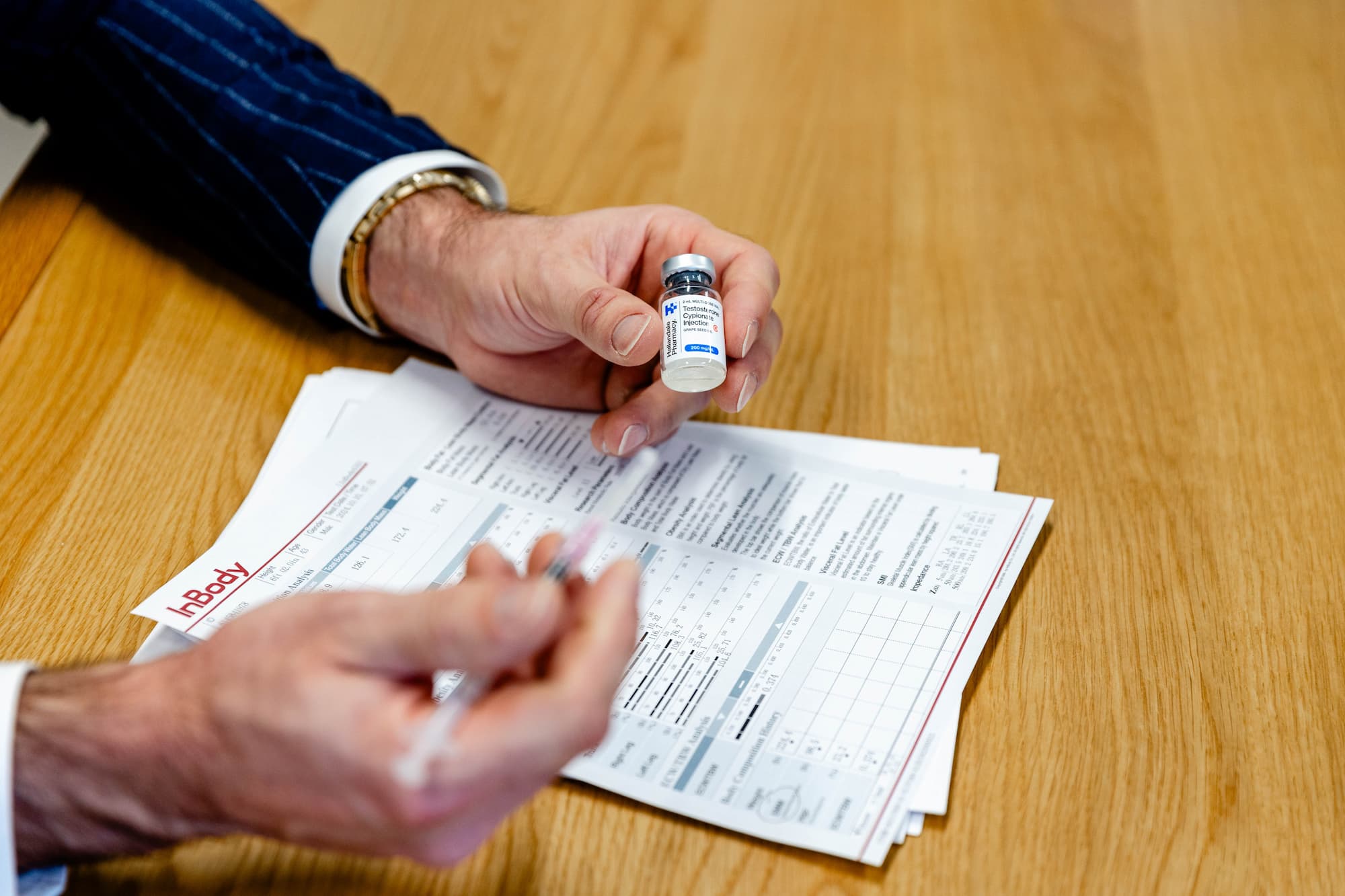 Close up of a medical provider explaining hormone optimization via informational papers